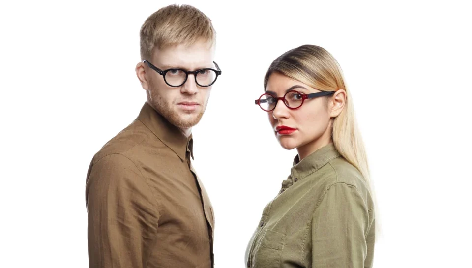 serious-young-male-female-employees-wearing-eyeglasses-staring-with-concentrated-annoyed-expressions-posing